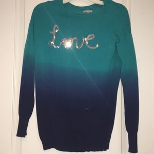 Ombré blue sweater saying love.